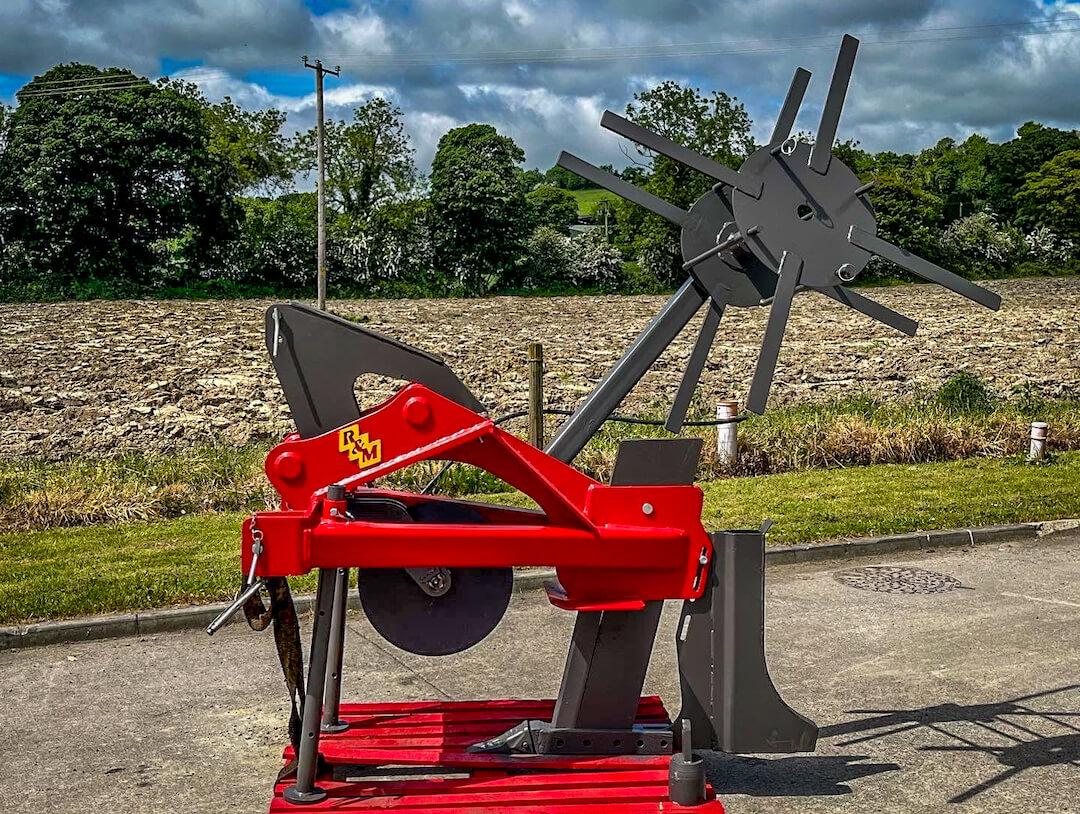 An excavator mole plough with a pipe layer attachment for land drainage ireland